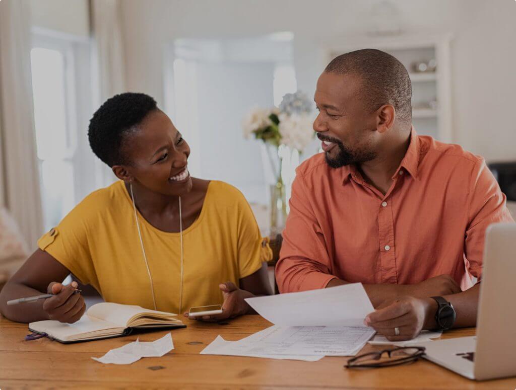 a woman and a man are talking by the desk